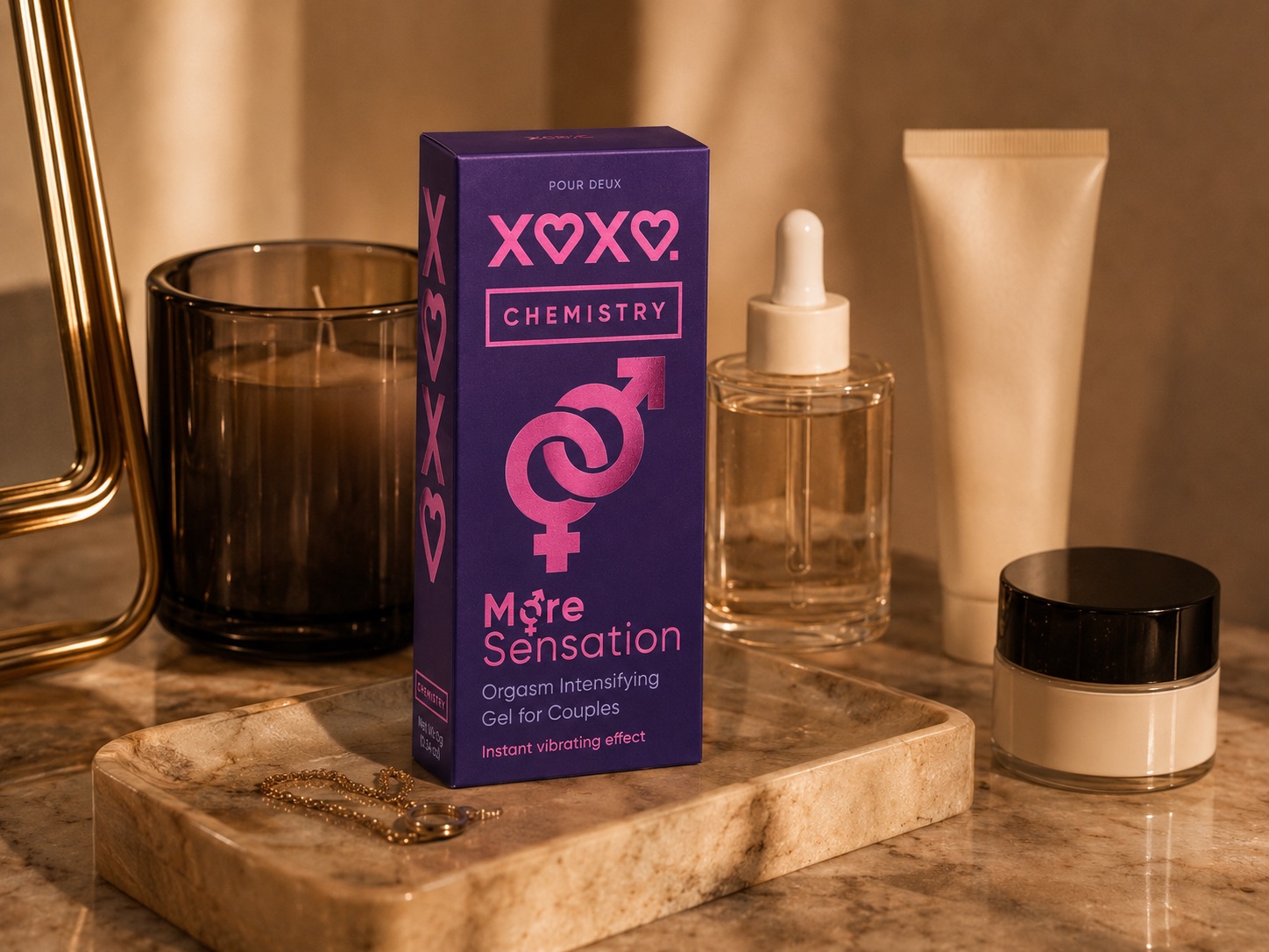 XOXO Chemistry standing among everyday cosmetics on a marble bathroom tray